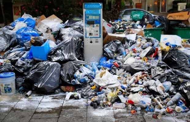 A parking meter is seen between a pile of garbage on a Beirut street, Lebanon, Tuesday, July 21, 2015. (AP/Hassan Ammar)